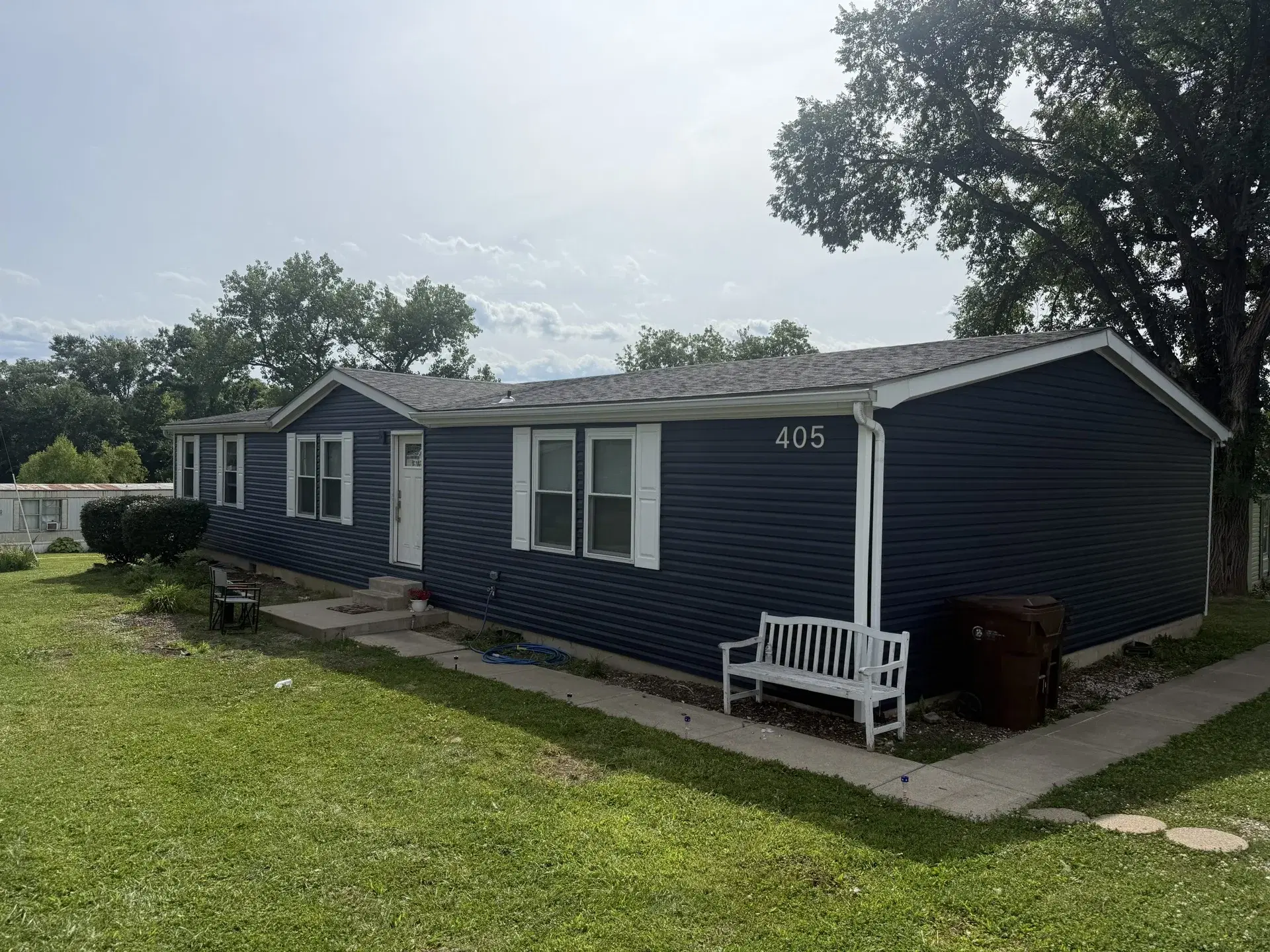 Home with navy blue siding and white exterior trim