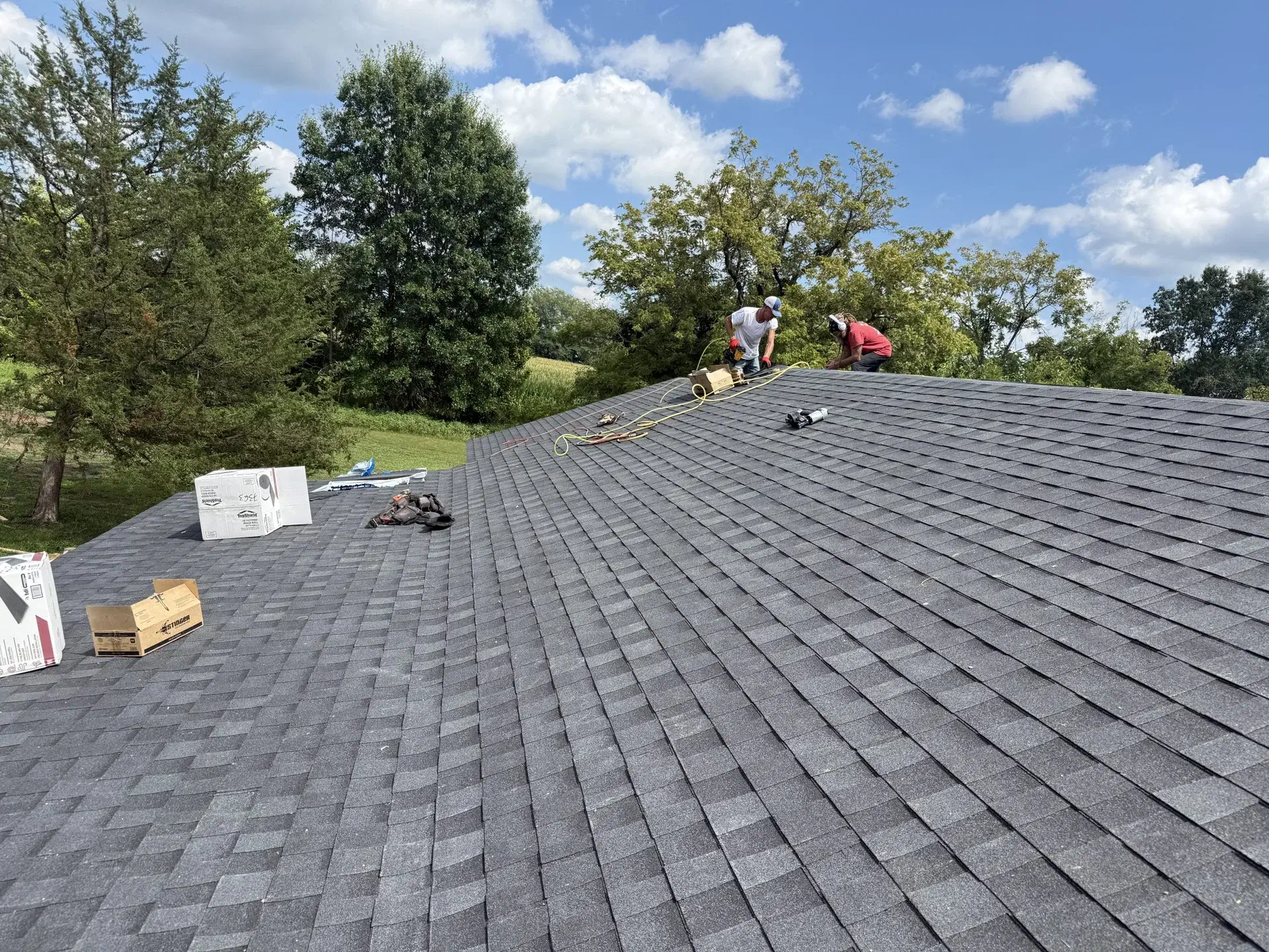 Shingle roofing work in progress on a residential home